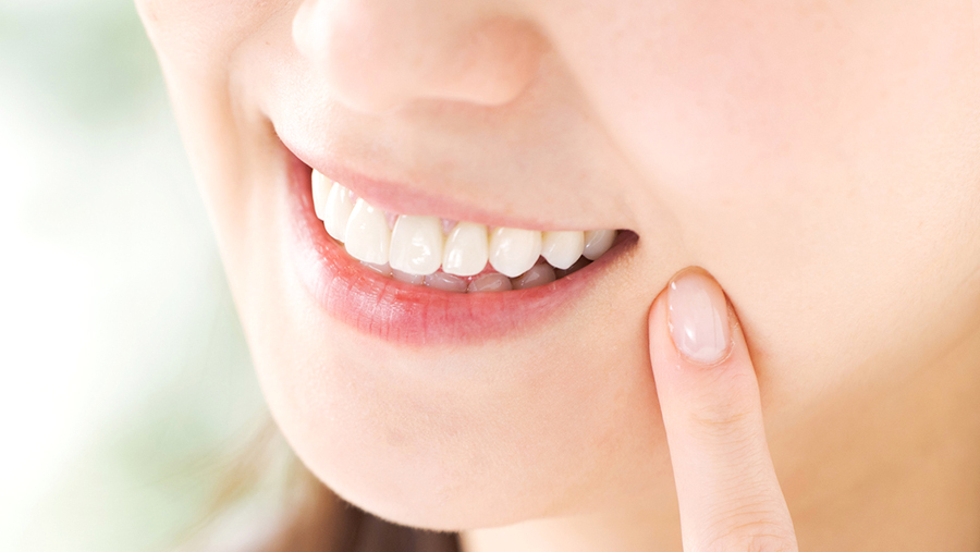 健康な歯で笑っている女性の口元